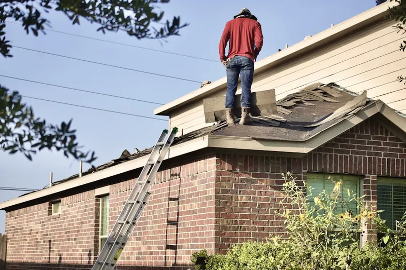 Professional roofer working on a residential roof in Parkland